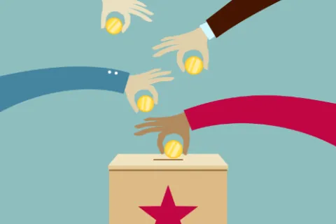 Des mains effectuent des dons dans une grosse boite portant une étoile