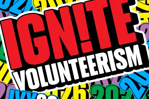 Graphic with bold text "IGNITE VOLUNTEERISM" on a vibrant, colorful patterned background with numbers.