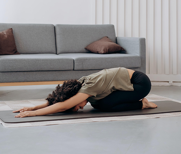 A person doing a yoga stretch in their living room.