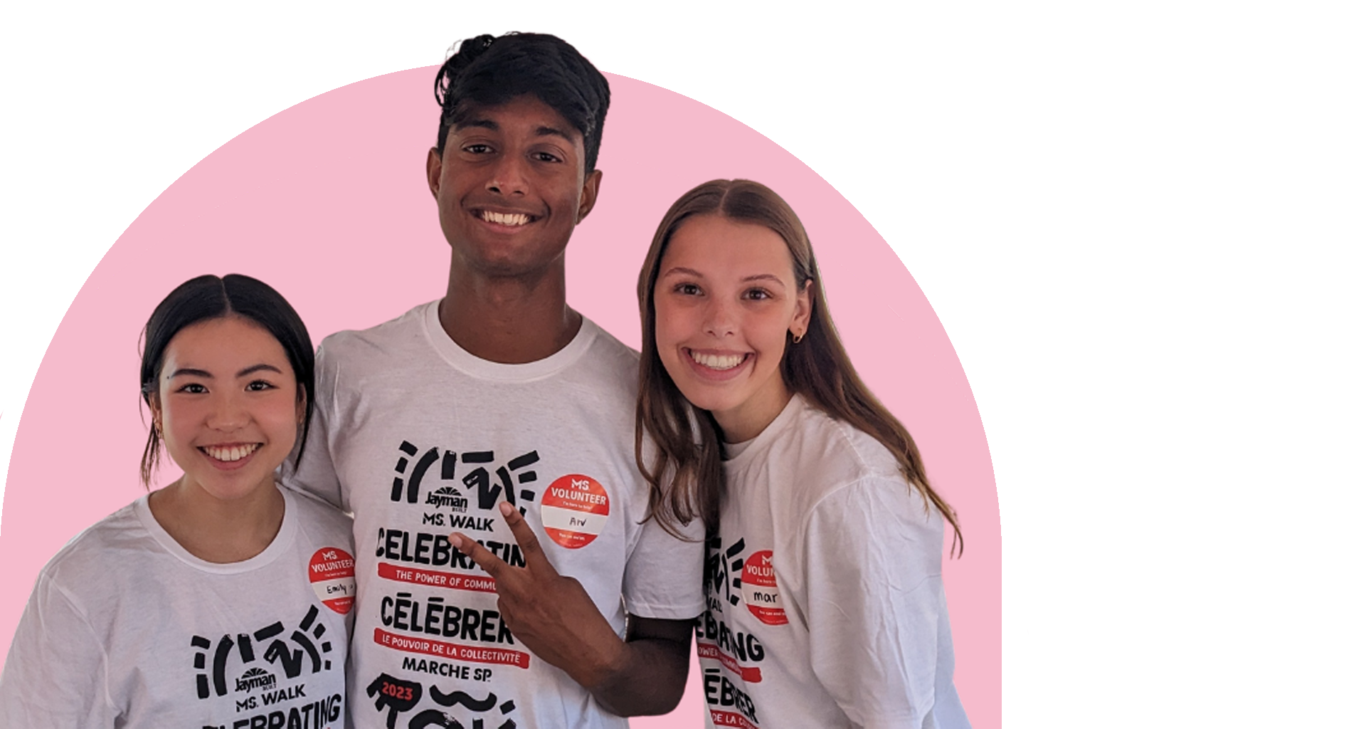 A group of three young adults wearing matching t-shirts. They are smiling.