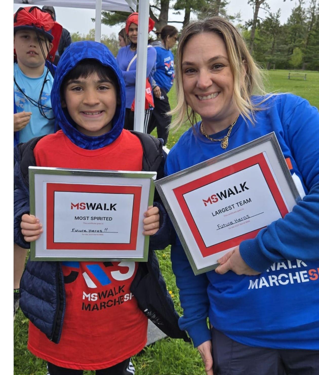 Frankie and his mom, Erica, holding their framed MS Walk awards.