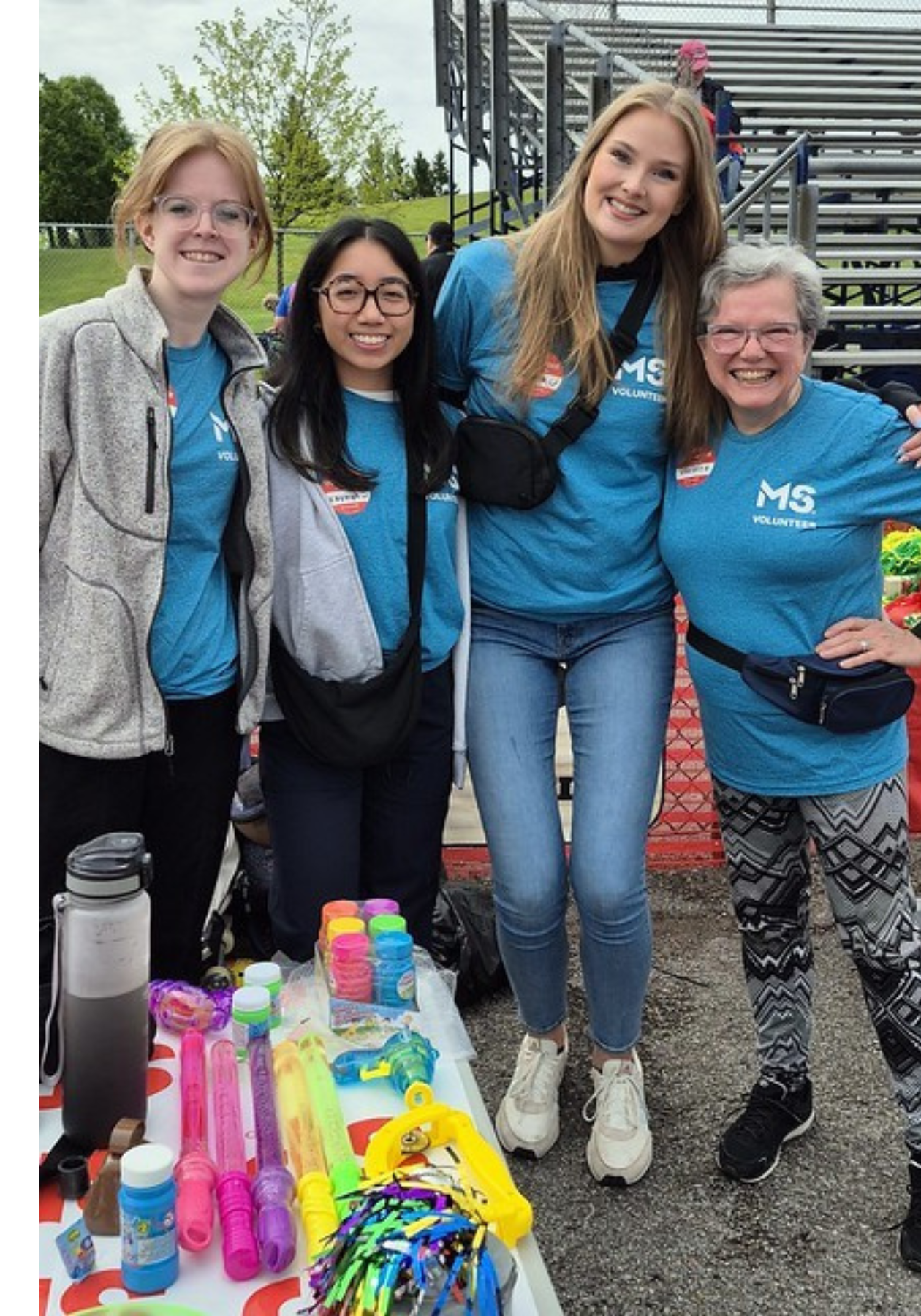 Kayleigh and three volunteers, wearing blue shirts.