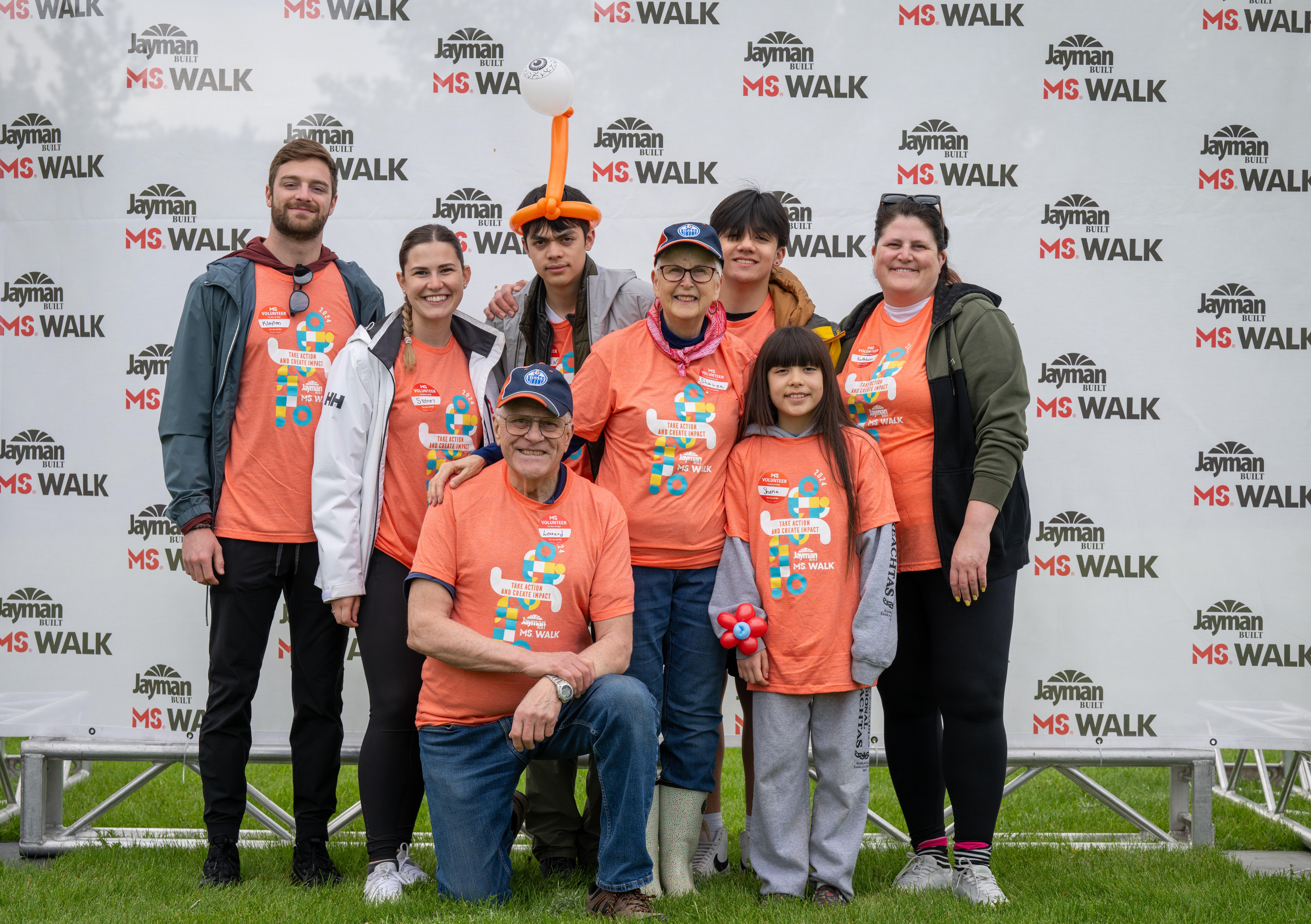 Sharon and Len with their family wearing orange MS Walk t-shirts.