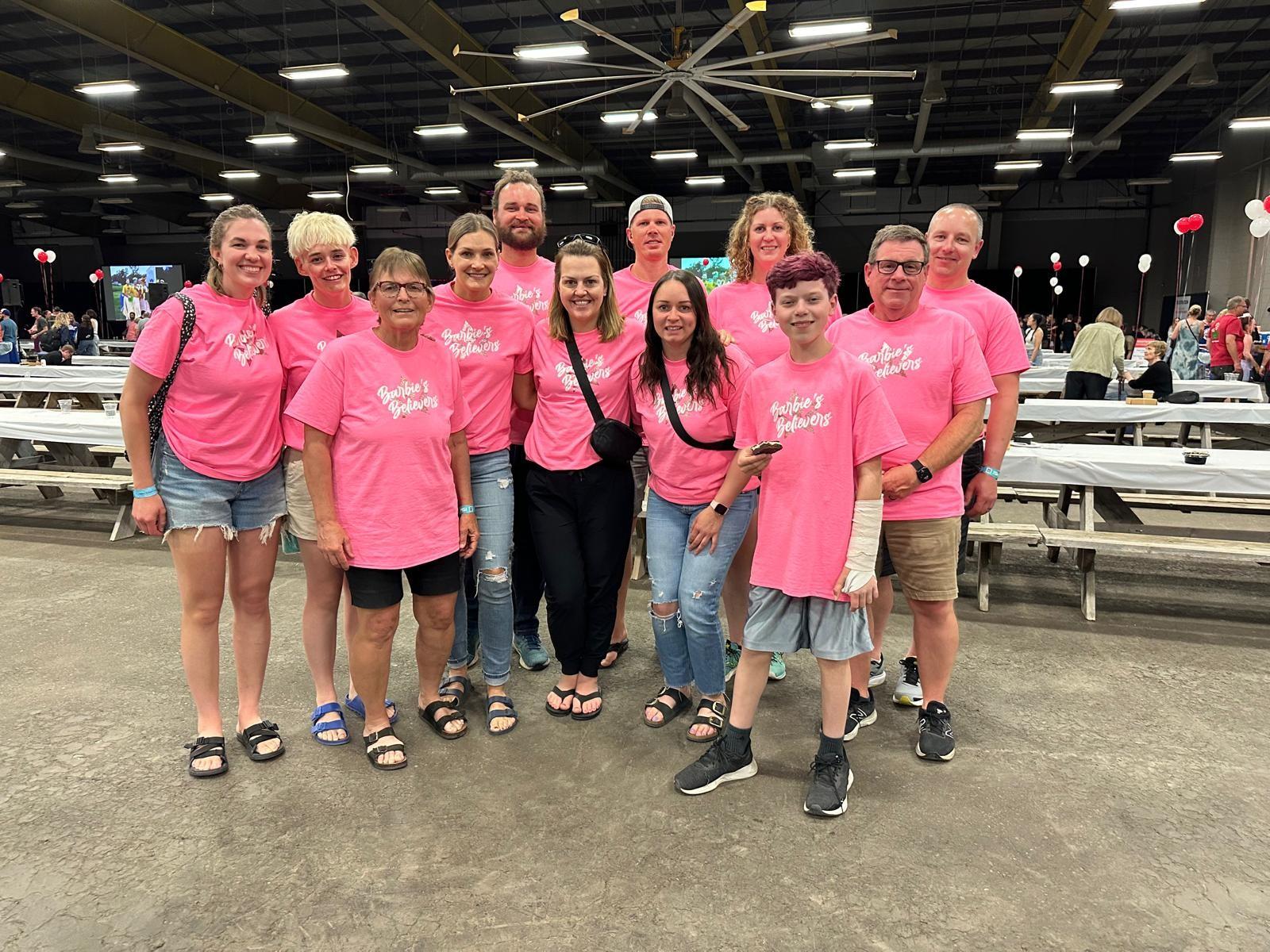 Alli and the Barbie's Believers team wearing matching pink t-shirts.
