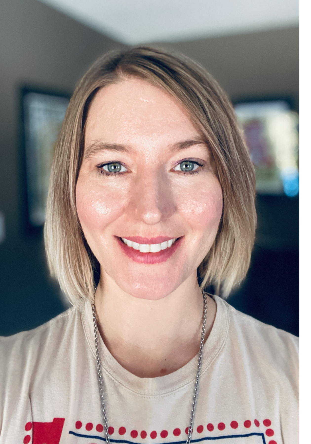 Jaclyn with short blonde hair wearing a casual top, photographed indoors.