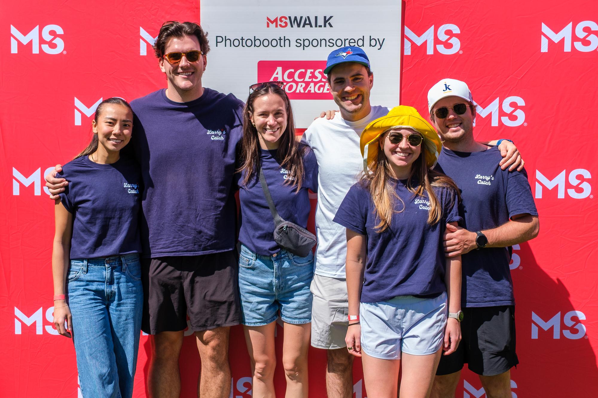 Glen and team members wearing Larry's Catch shirts, smiling at MS Walk.
